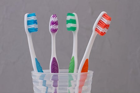 several toothbrushes in a cup