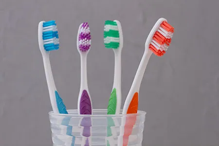 several toothbrushes in a cup