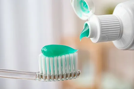 toothbrush with toothpaste on it