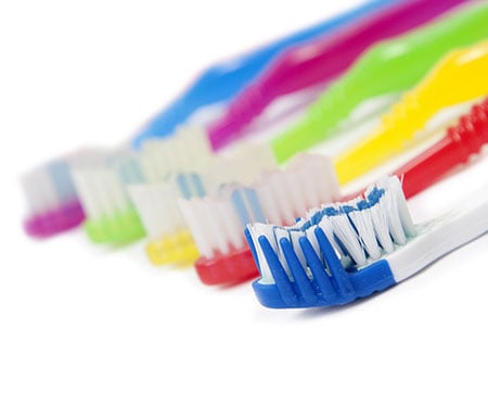 row of colorful toothbrushes